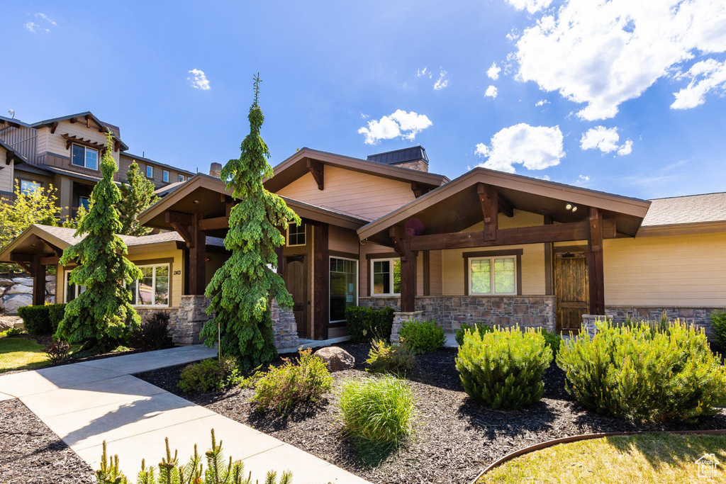 Craftsman inspired home featuring stone siding