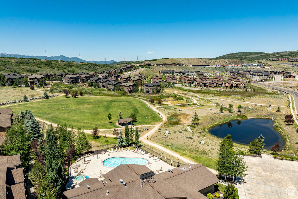 Aerial view of residential area featuring a water and mountain view and a pool