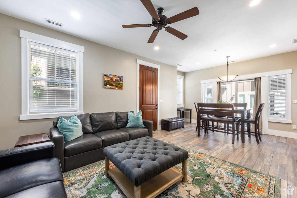 Living area featuring ceiling fan, recessed lighting, healthy amount of natural light, and wood finished floors