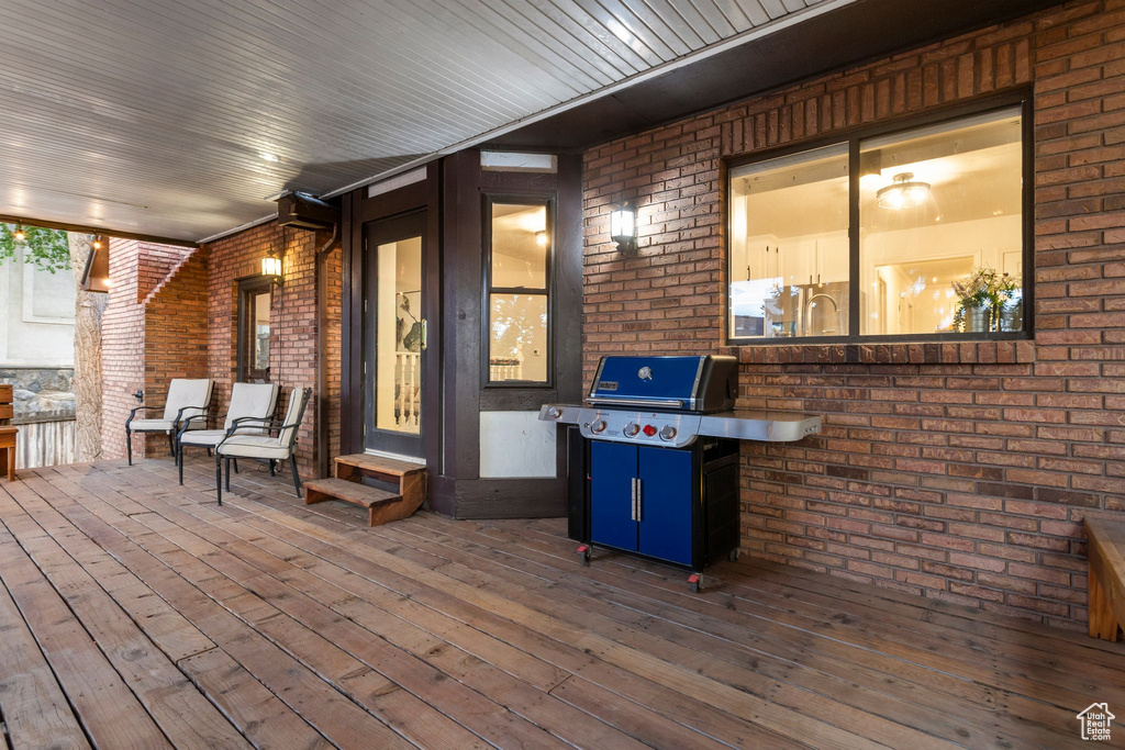 Wooden deck featuring area for grilling