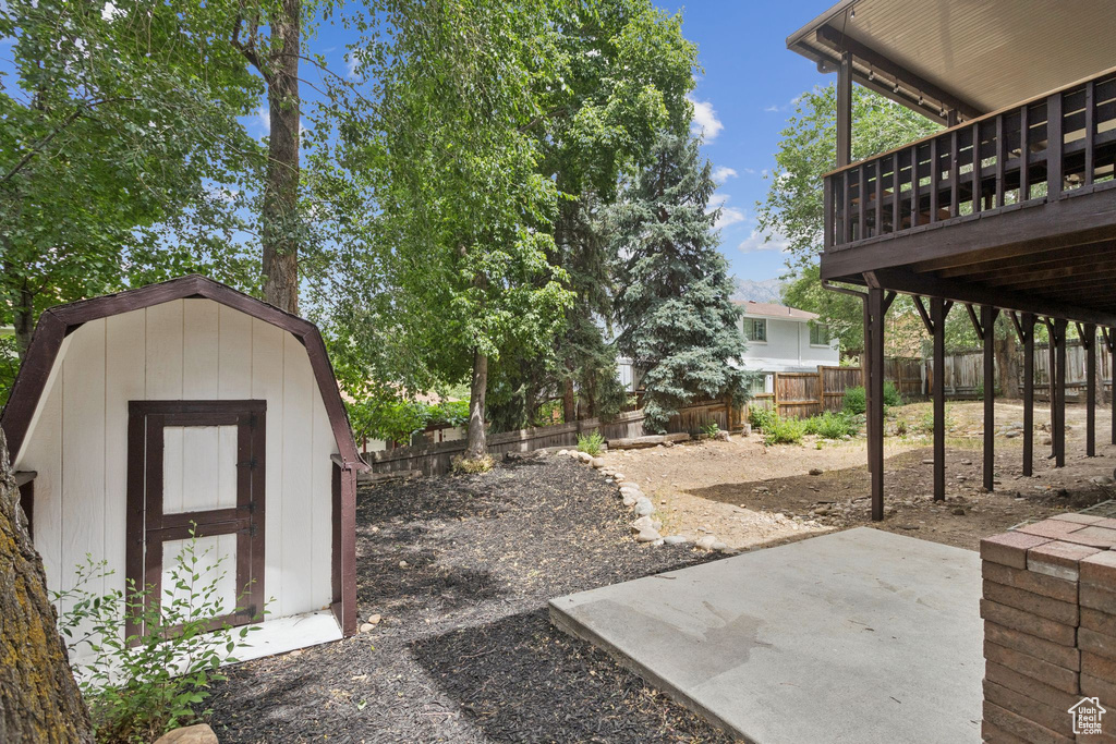 View of yard with a storage shed and a patio