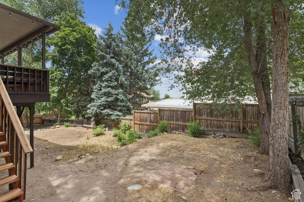 Fenced backyard featuring stairs