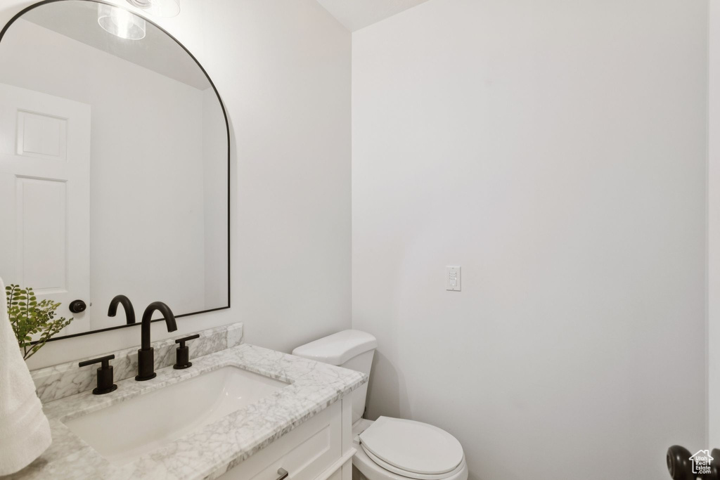Half bathroom featuring toilet and vanity