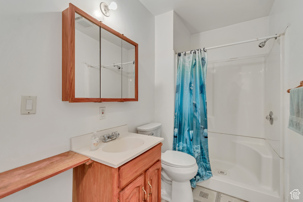 Bathroom with vanity and a shower with shower curtain