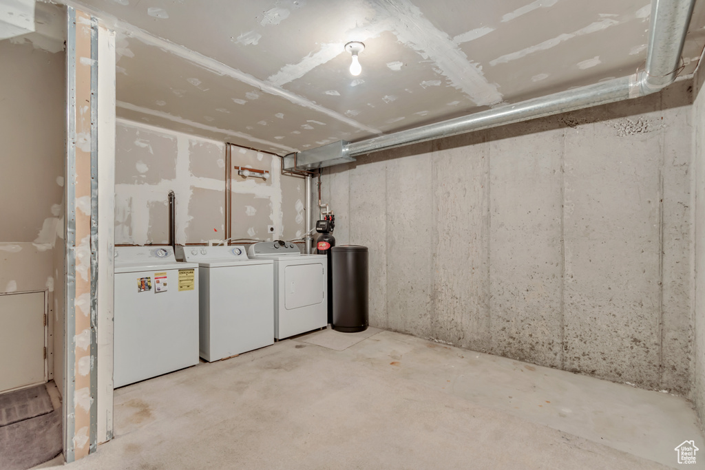 Unfinished basement featuring washer and clothes dryer