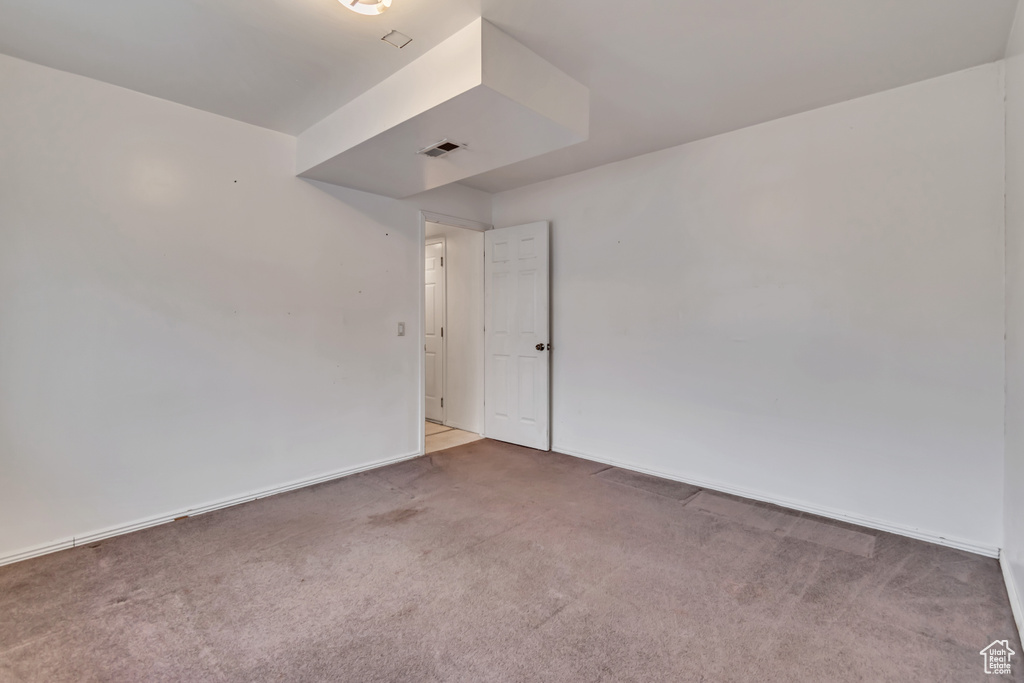 Carpeted empty room with baseboards