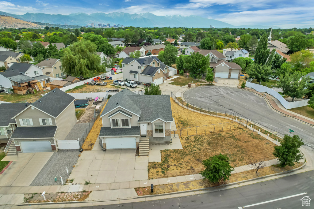Aerial perspective of suburban area with a mountainous background
