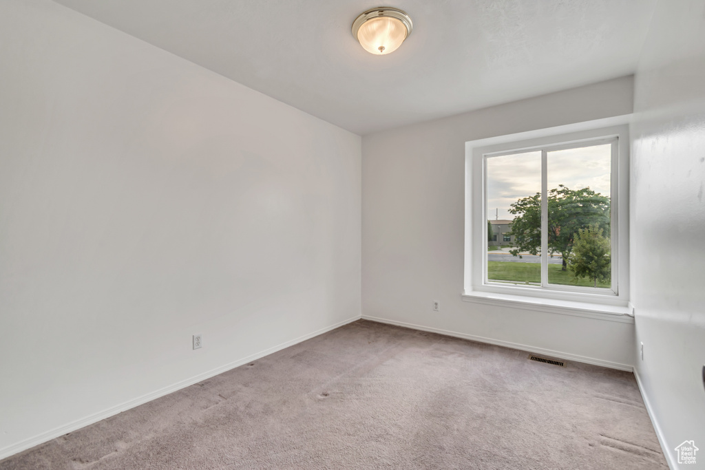 Spare room featuring carpet