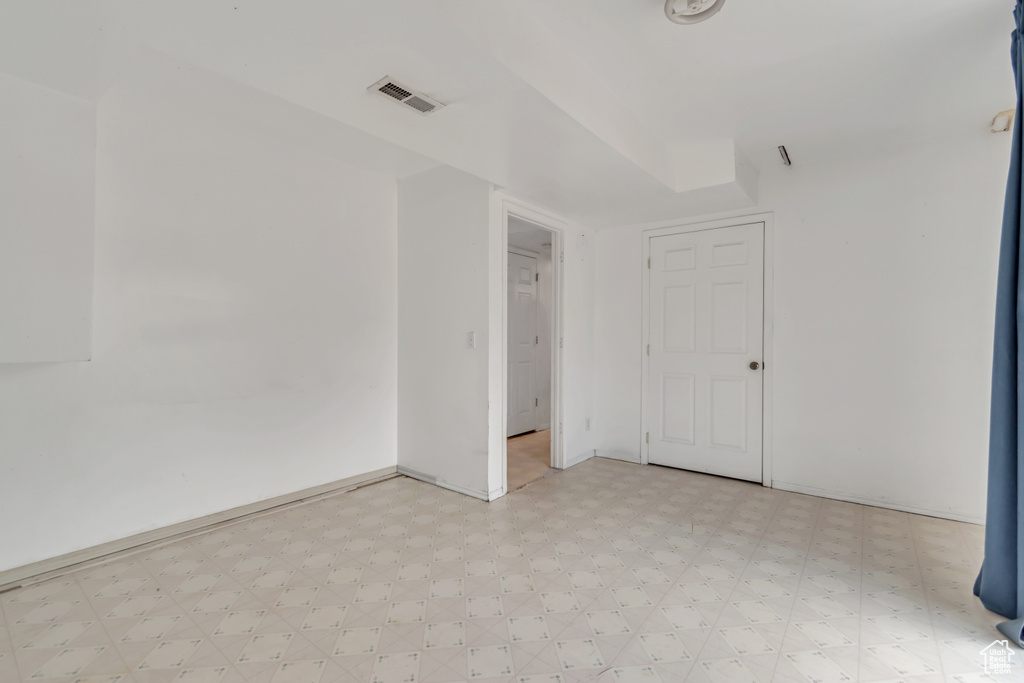 Unfurnished room featuring light flooring and baseboards