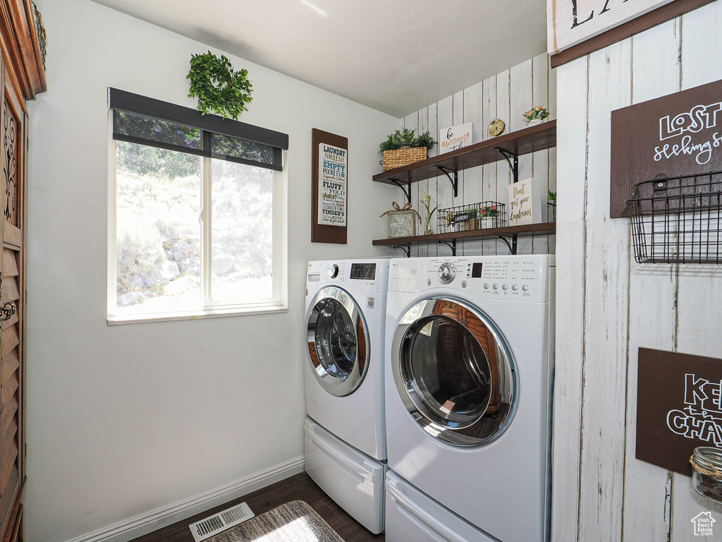 Washroom featuring washing machine and dryer and dark wood-style floors