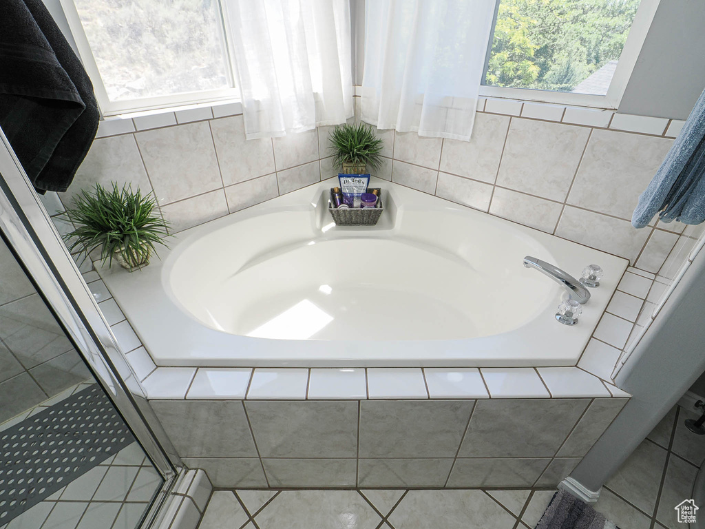 Bathroom featuring a bath and tile patterned flooring