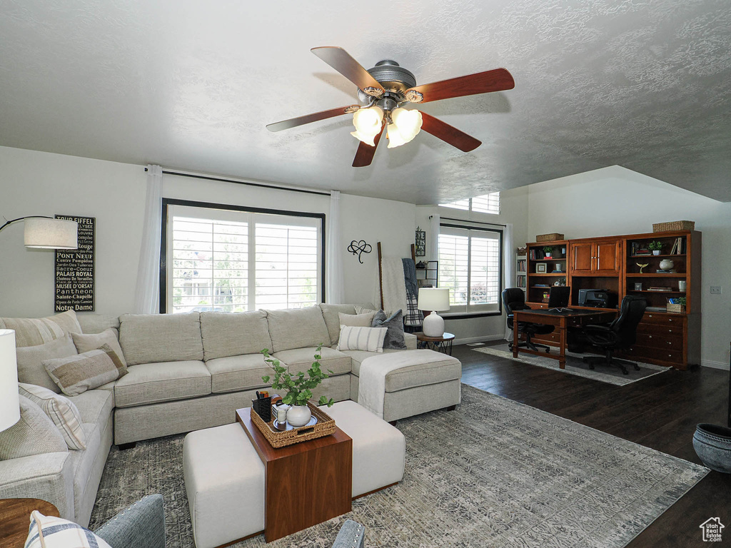 Living area with ceiling fan, wood finished floors, and an office area