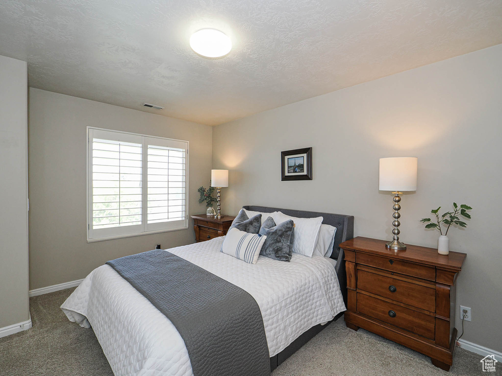 Carpeted bedroom with baseboards