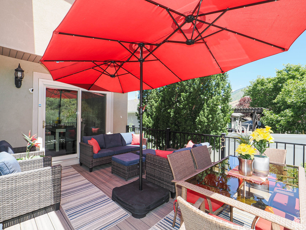 Wooden terrace featuring outdoor lounge area