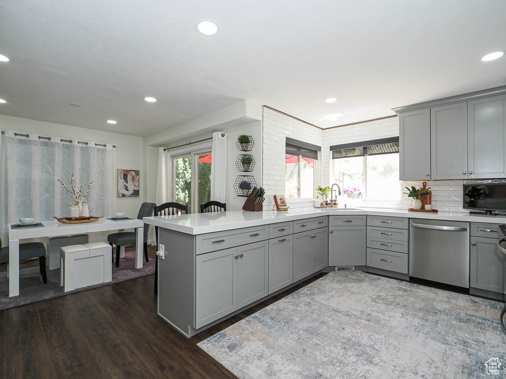 Kitchen featuring gray cabinets, dishwasher, light countertops, and recessed lighting