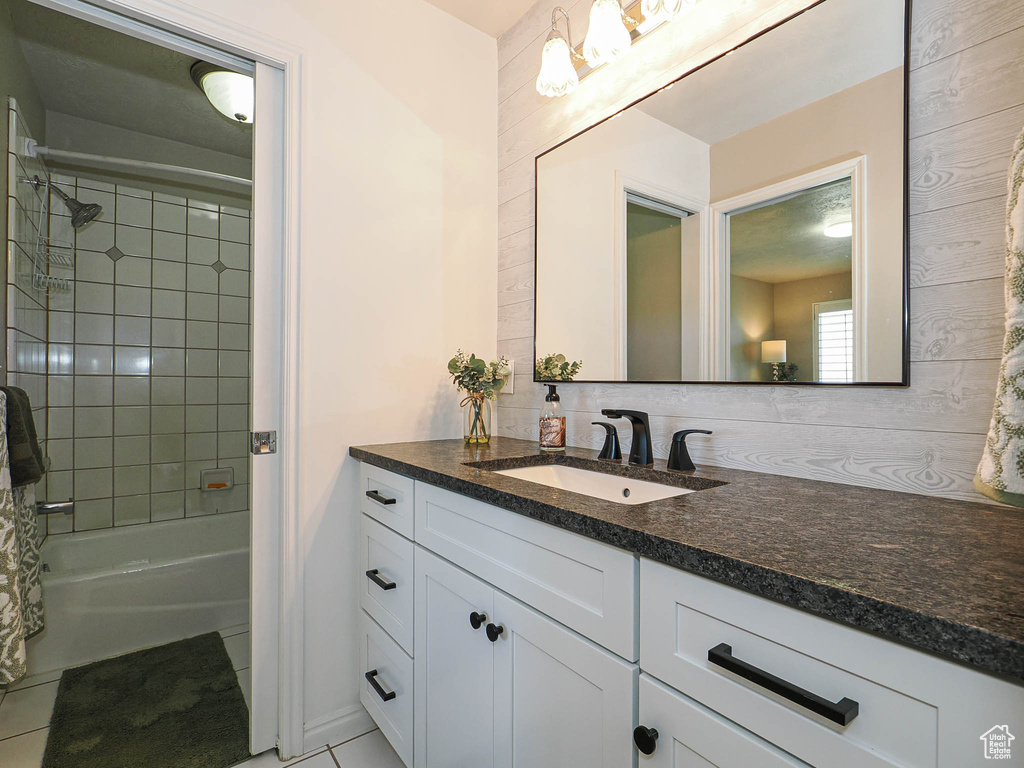 Full bathroom with vanity, decorative backsplash, tile patterned floors, and bathing tub / shower combination