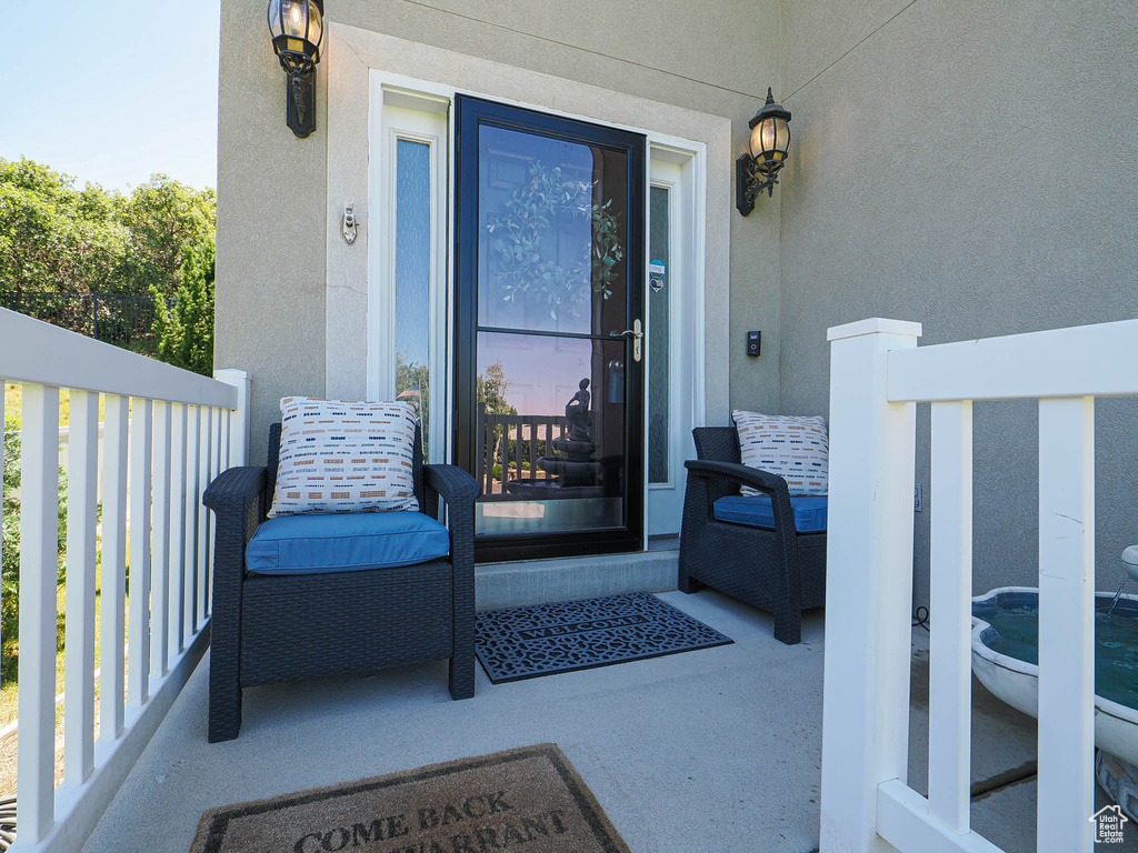 Property entrance featuring stucco siding and a porch
