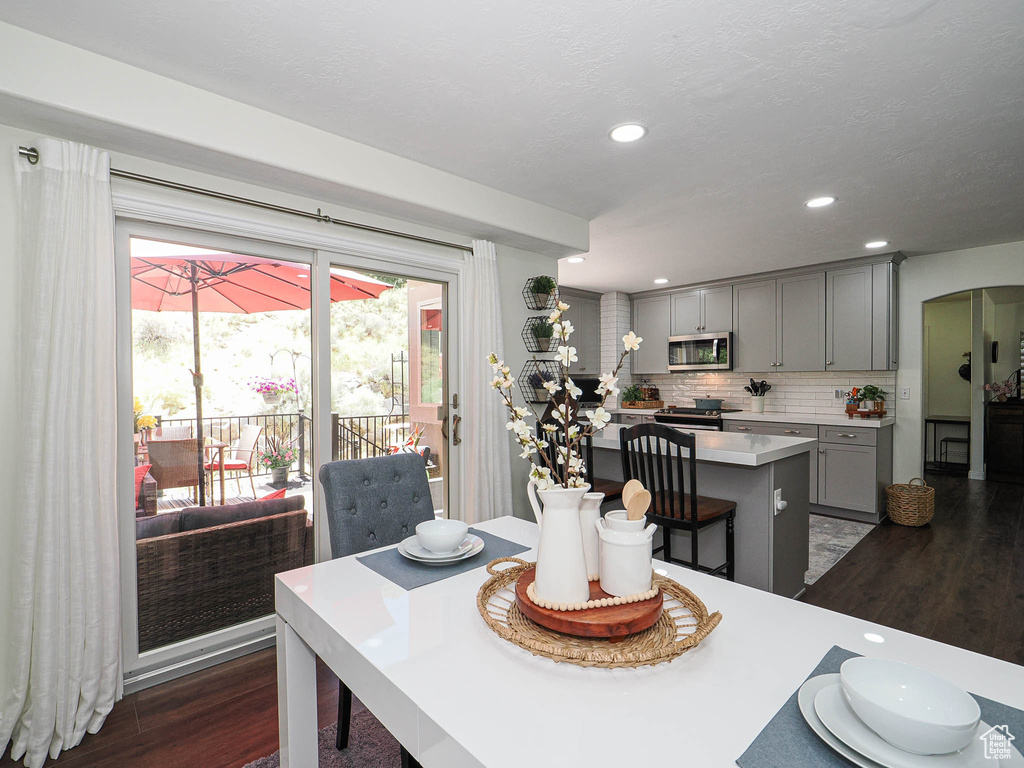 Dining room featuring dark wood-type flooring and recessed lighting