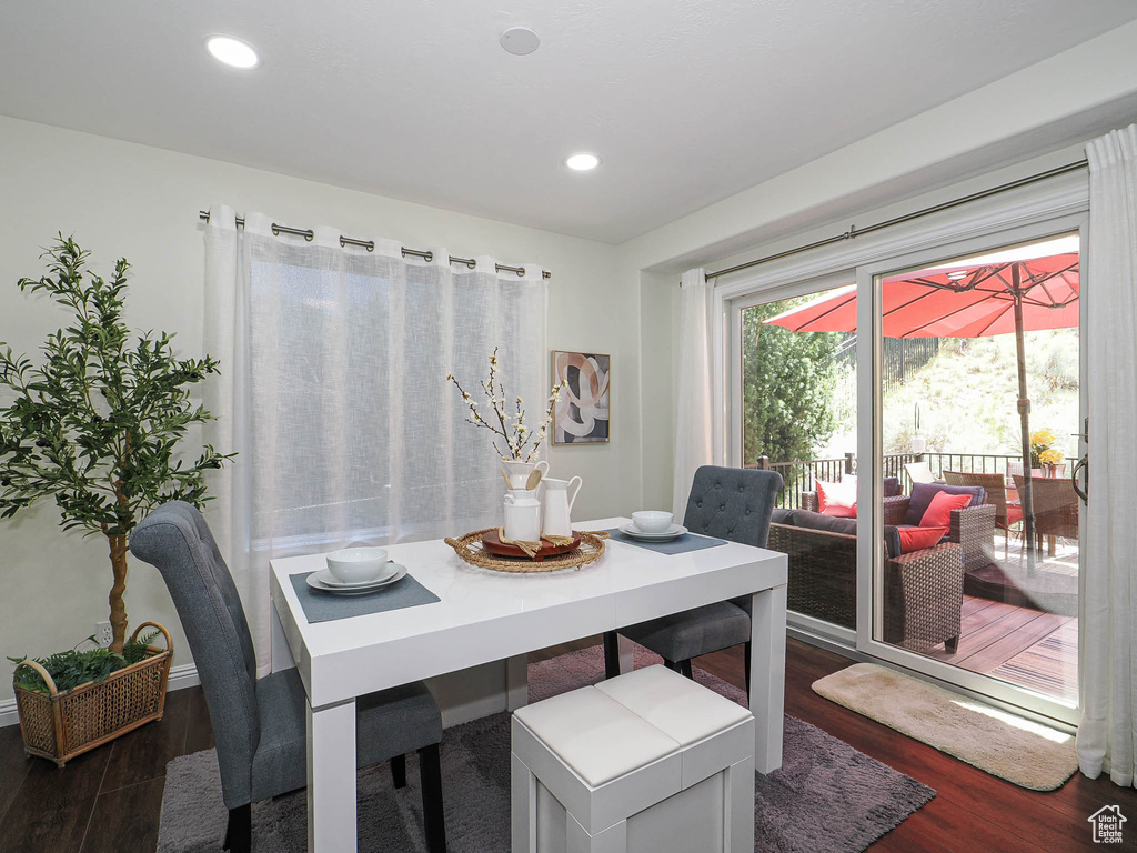 Dining area featuring dark wood-style floors and recessed lighting
