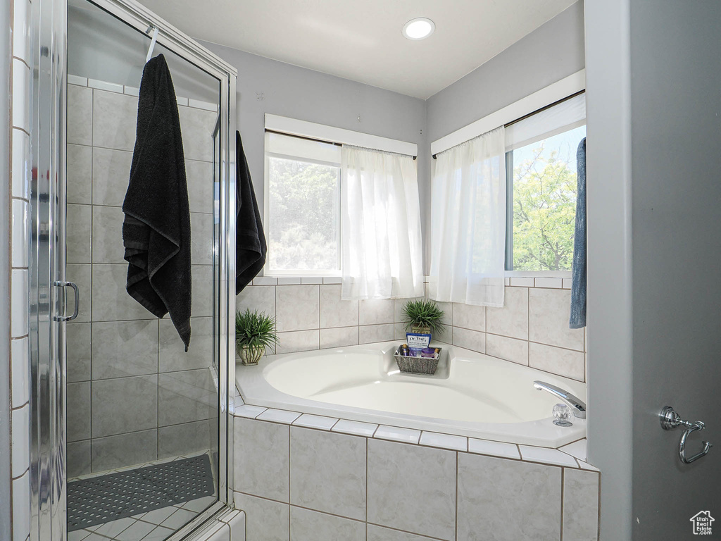 Full bath featuring a garden tub, a stall shower, plenty of natural light, and recessed lighting