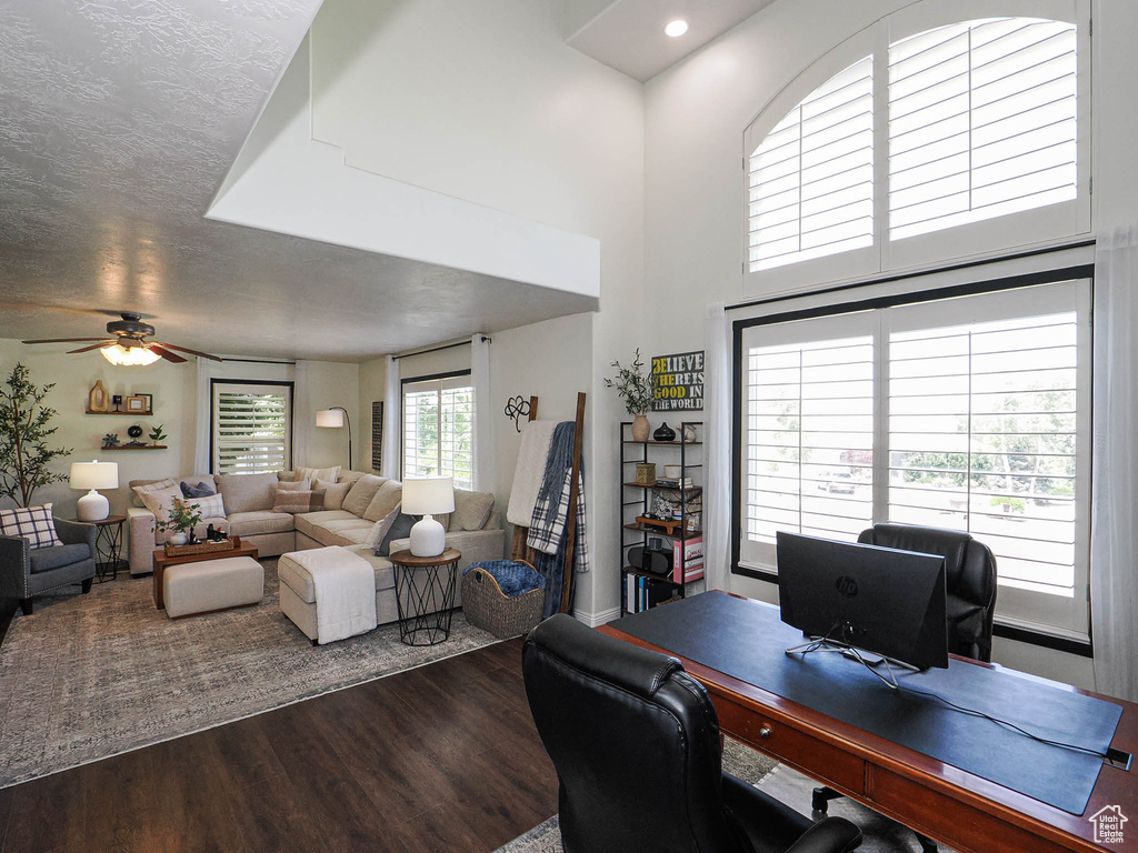 Office space featuring dark wood-style flooring and a ceiling fan