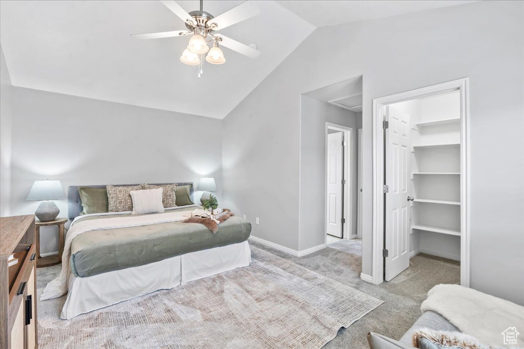 Bedroom with carpet floors, lofted ceiling, a spacious closet, ceiling fan, and a closet
