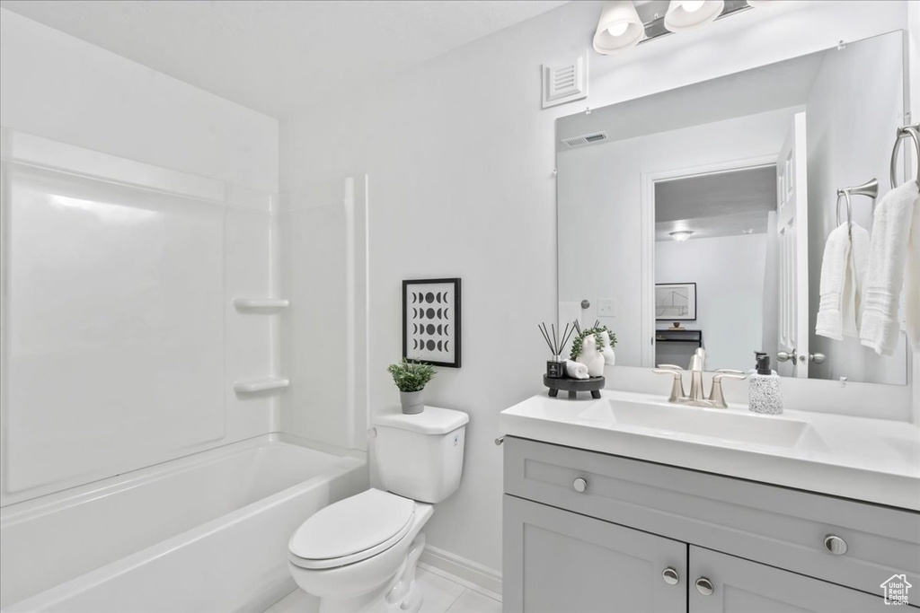 Bathroom with vanity, shower / bathtub combination, and tile patterned floors