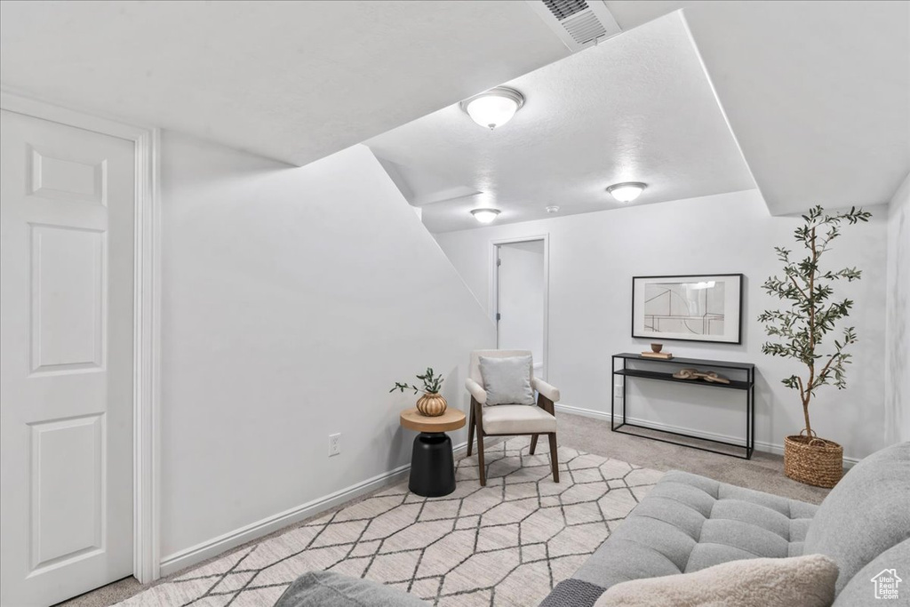 Sitting room featuring carpet floors and baseboards