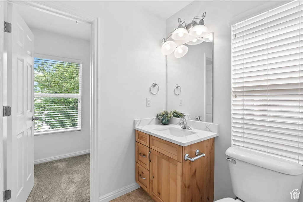 Half bath featuring vanity and plenty of natural light