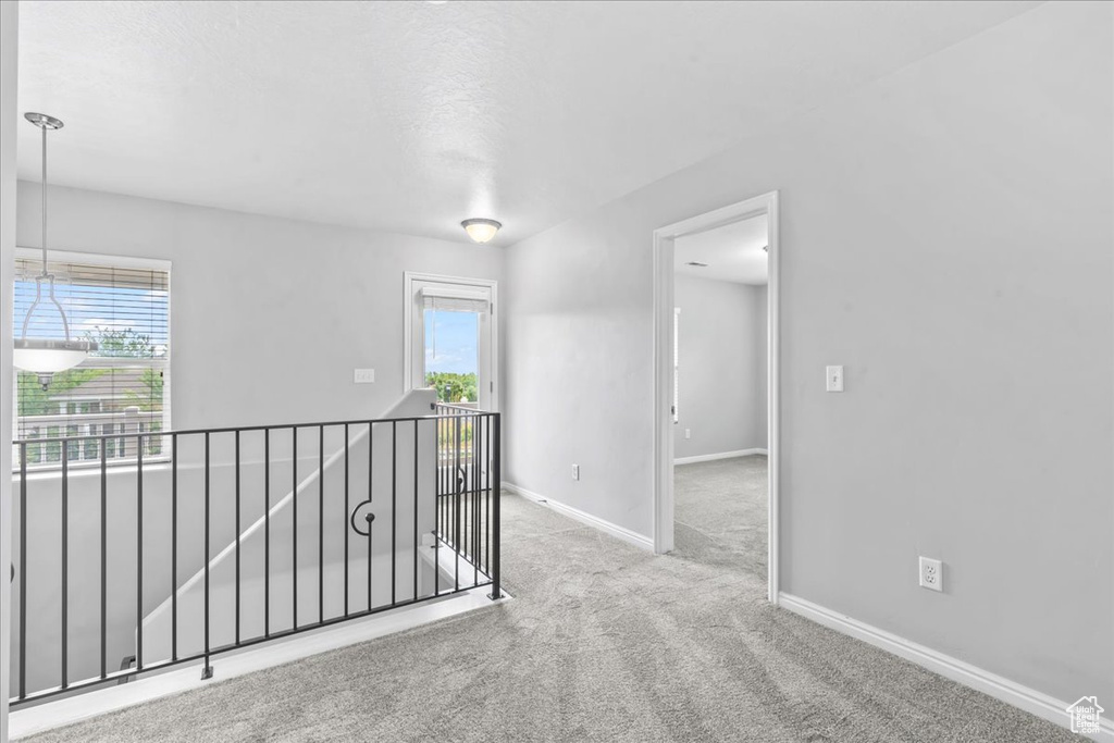 Carpeted empty room featuring baseboards