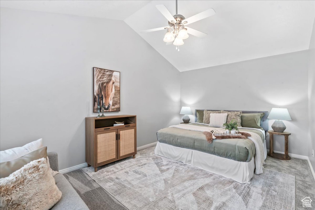 Carpeted bedroom featuring lofted ceiling and ceiling fan