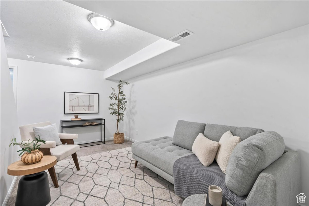 Living room with light carpet and baseboards