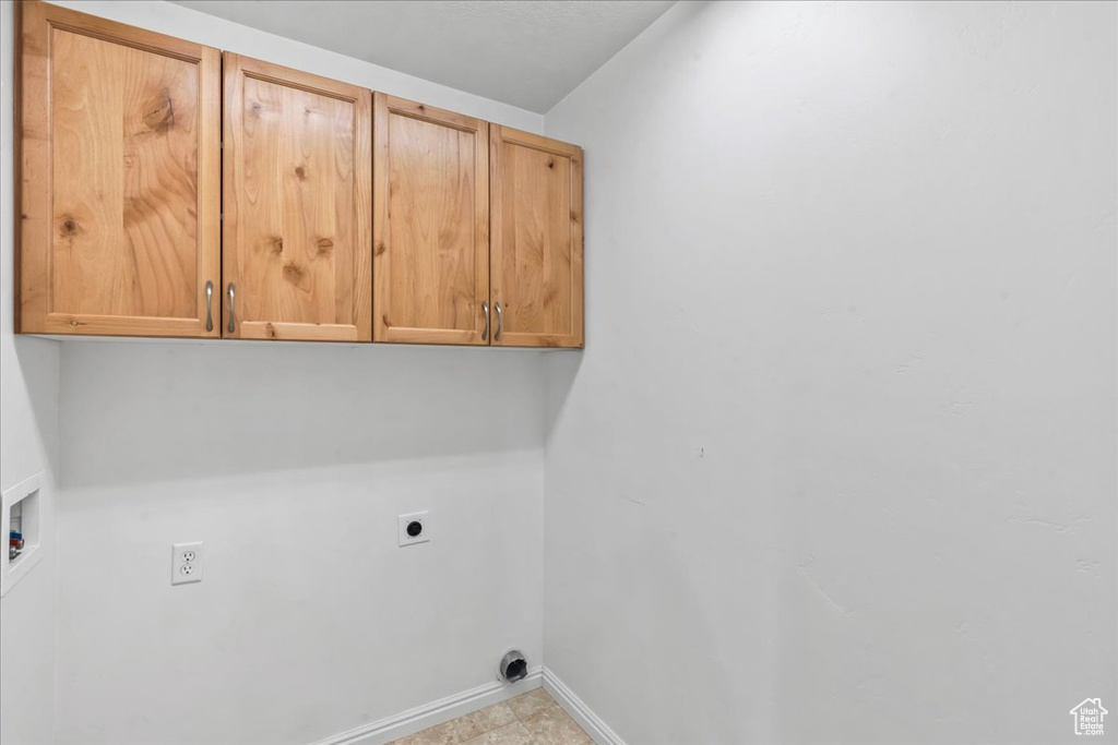 Laundry room featuring cabinet space, hookup for an electric dryer, and hookup for a washing machine