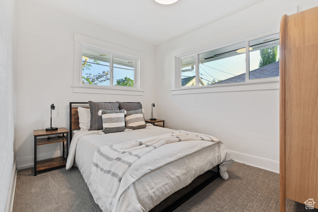 Bedroom featuring baseboards and carpet