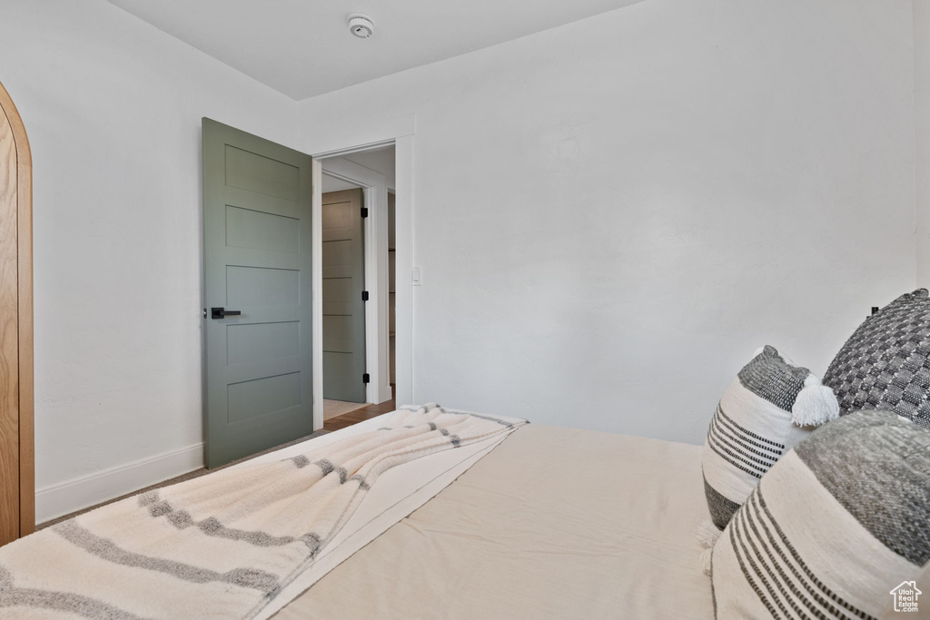 Bedroom featuring baseboards and arched walkways