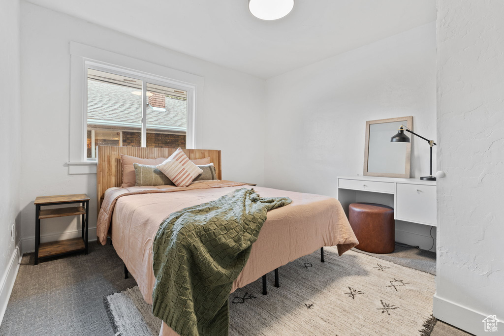 Carpeted bedroom featuring baseboards