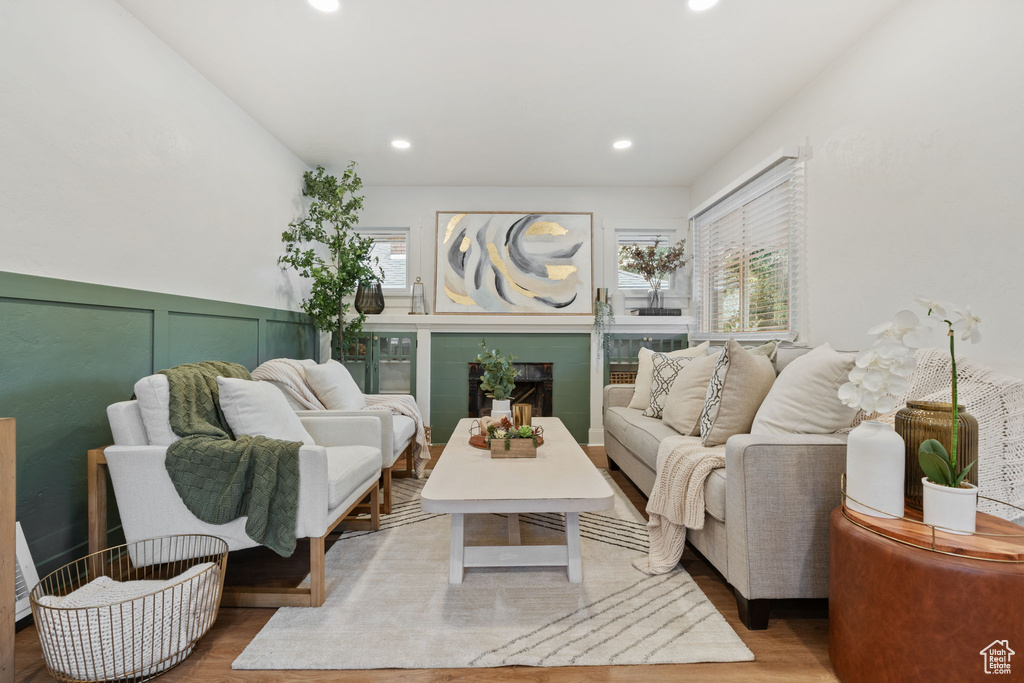 Living area with wood finished floors, recessed lighting, and a fireplace