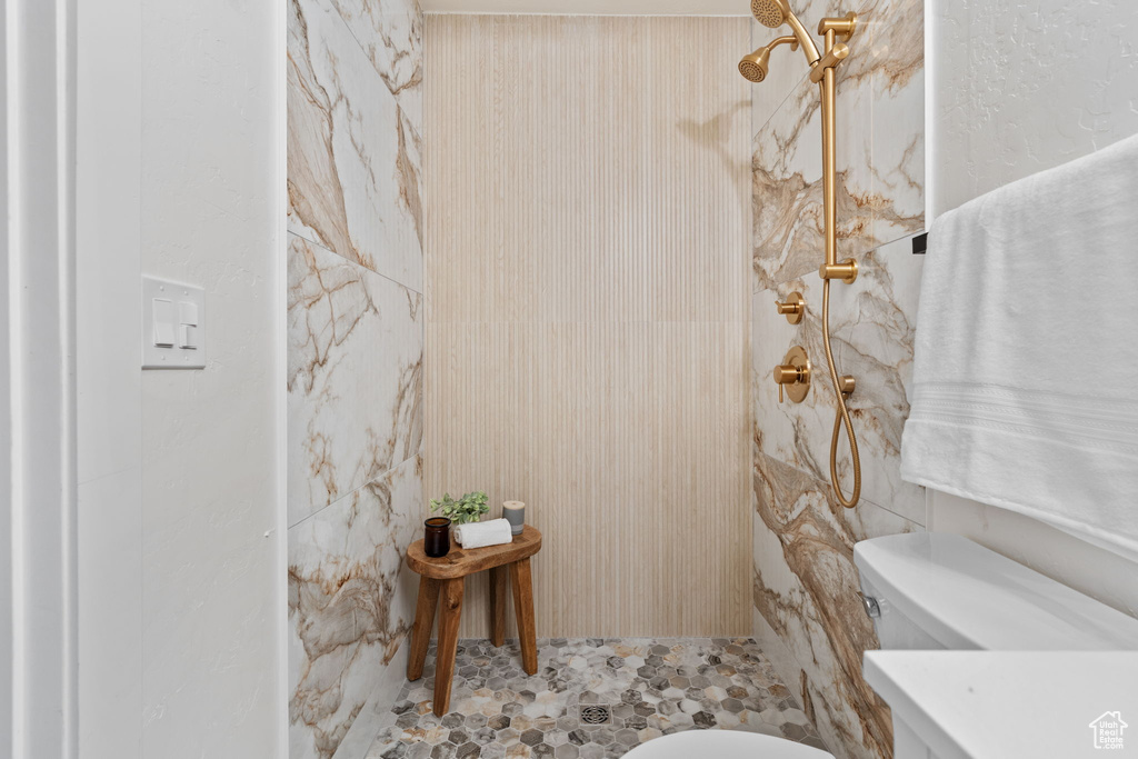 Full bathroom featuring a shower and toilet