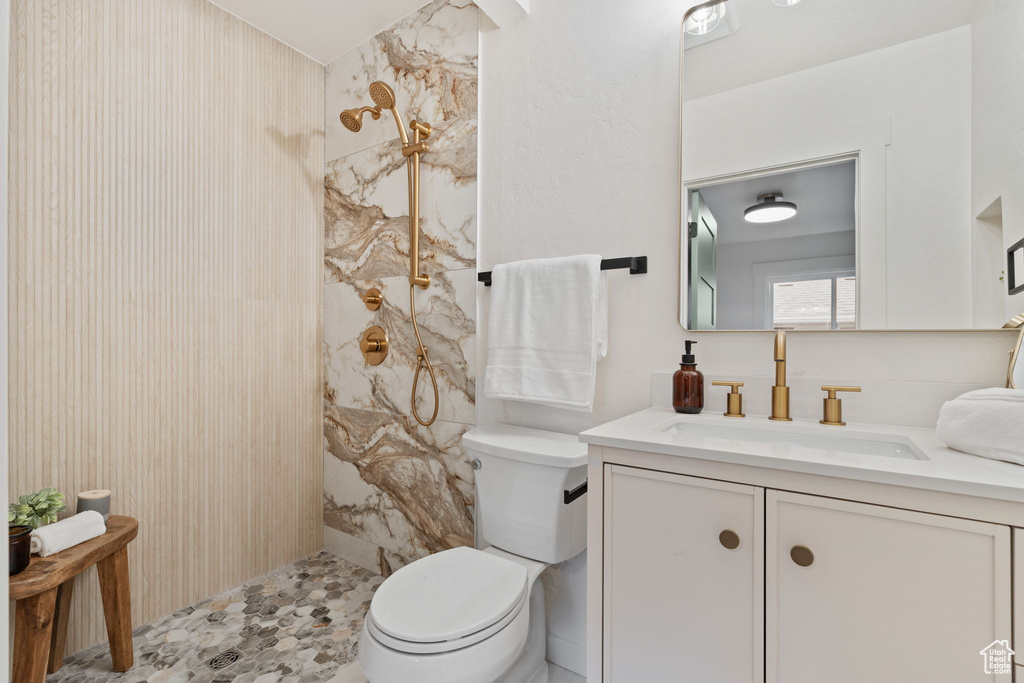 Full bathroom with vanity and a marble finish shower