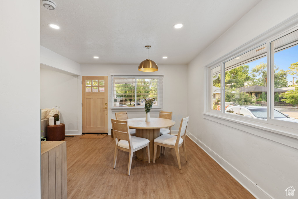 Dining space featuring healthy amount of natural light, light wood-type flooring, and recessed lighting