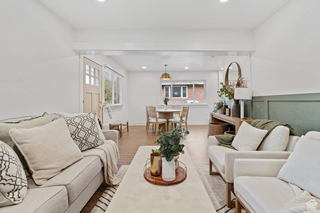 Living room featuring light wood-style flooring, healthy amount of natural light, and recessed lighting