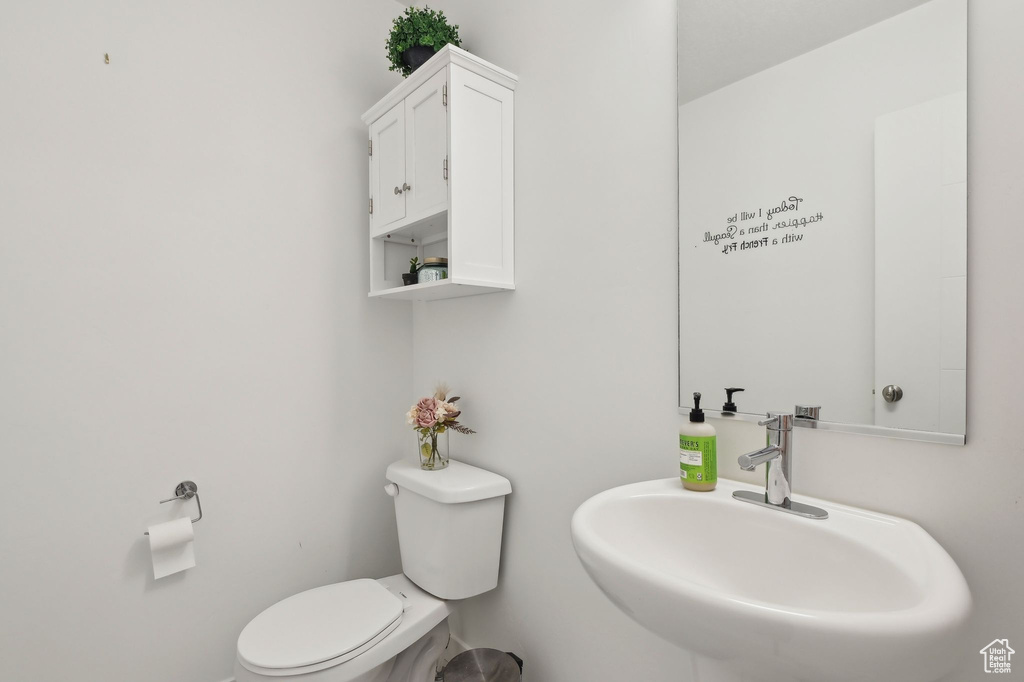 Half bathroom with a sink and toilet