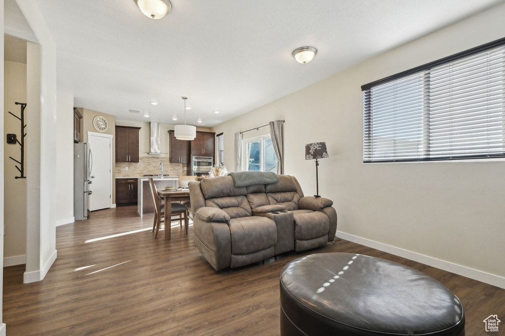 Living room featuring dark wood-style floors and recessed lighting