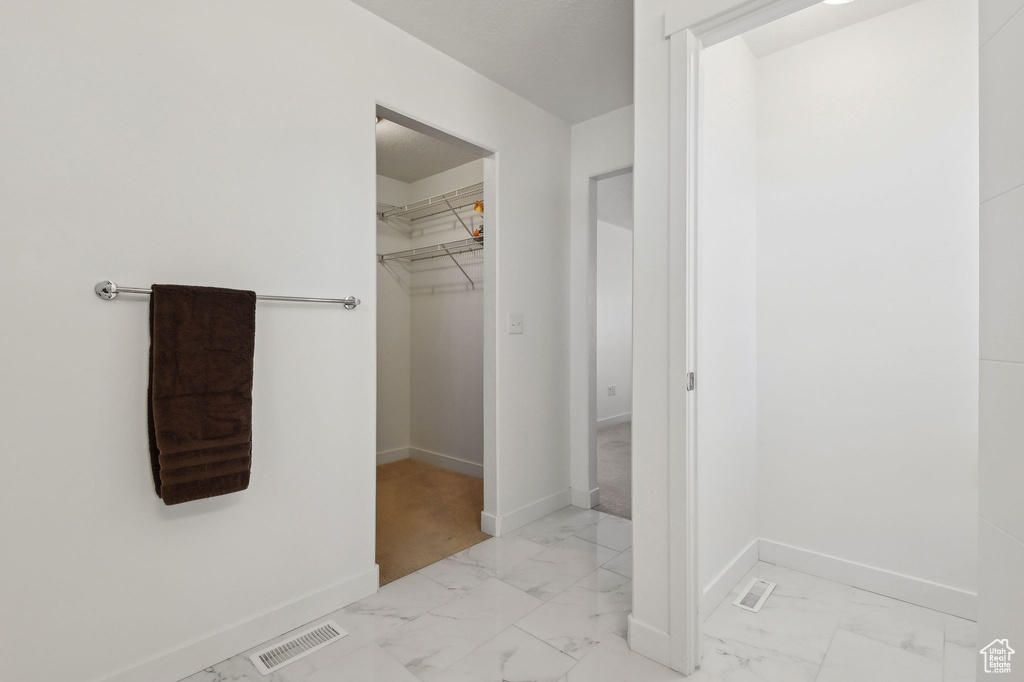 Bathroom featuring marble finish floors and baseboards