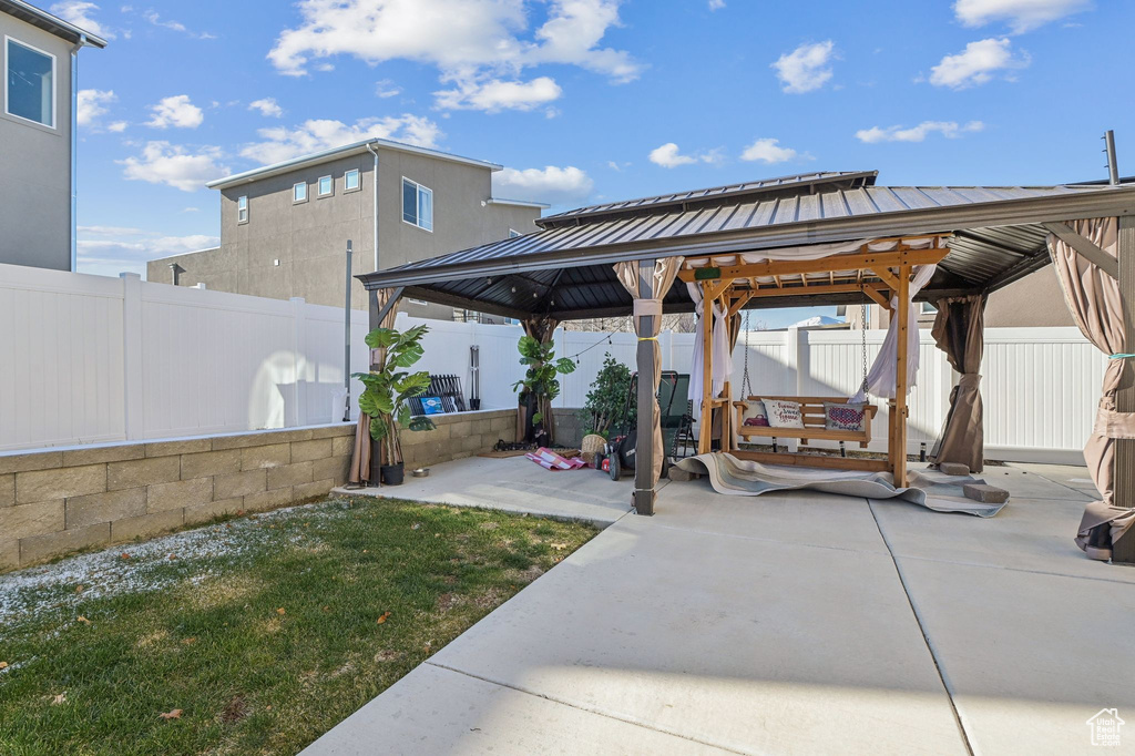 Fenced backyard with a gazebo and a patio