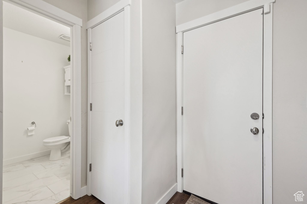 Entryway featuring marble look tiles and baseboards