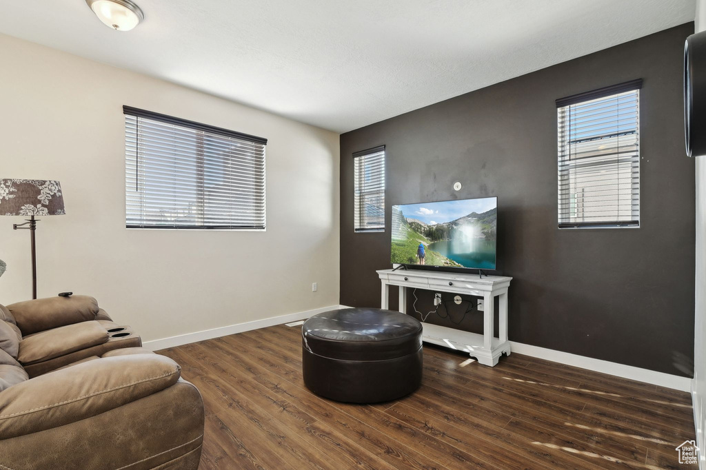 Living room with dark wood finished floors and baseboards