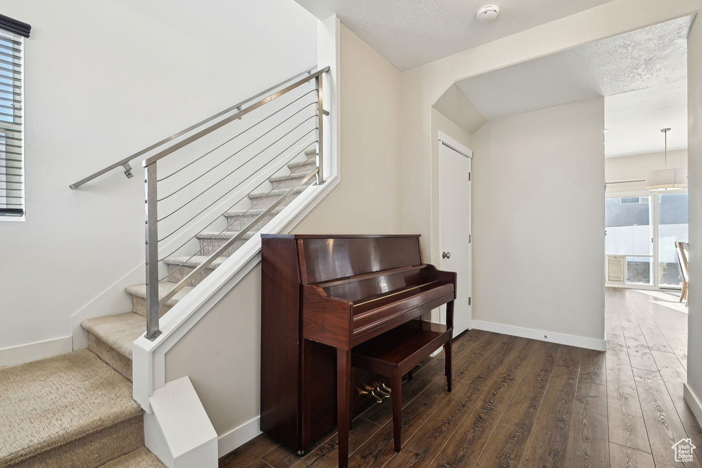 Staircase featuring hardwood / wood-style floors and baseboards