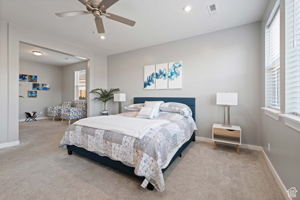 Carpeted bedroom featuring ceiling fan and recessed lighting