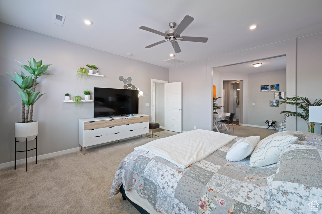 Bedroom with light colored carpet, recessed lighting, and ceiling fan
